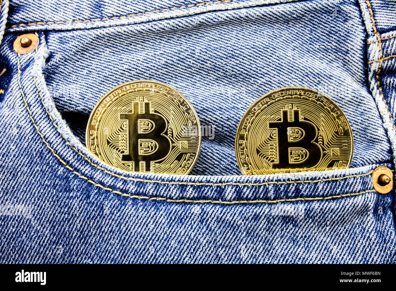 Two Golden Bitcoin Coins On The Pockets Of The Jeans Concept Of - 